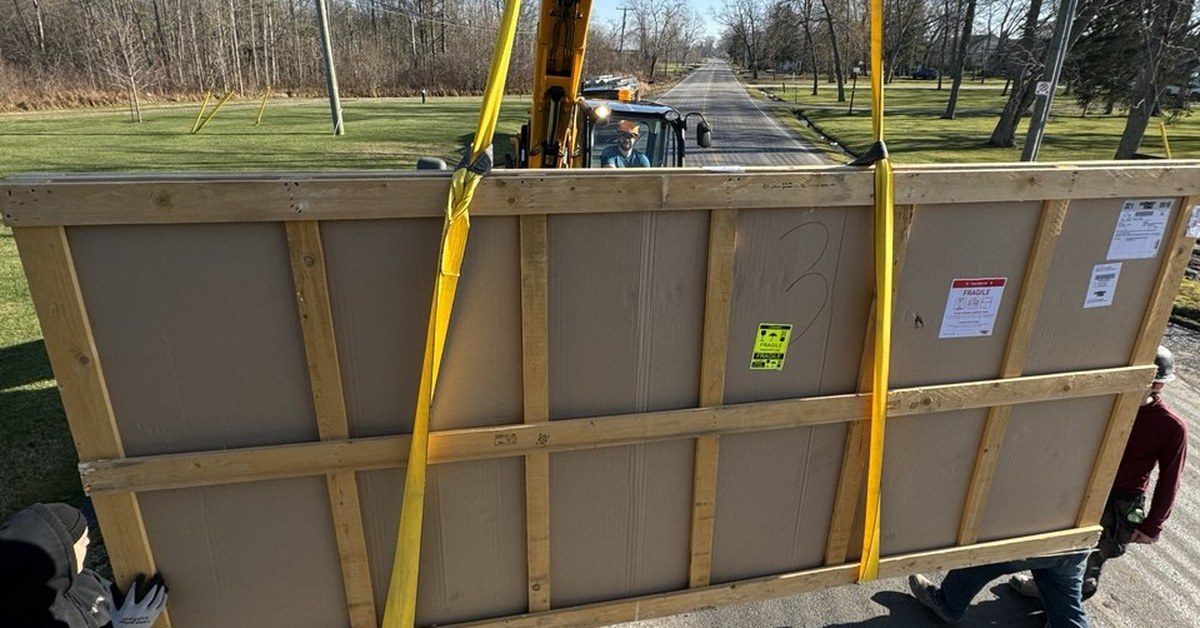 Heavy furniture crate being lifted with equipment during a move