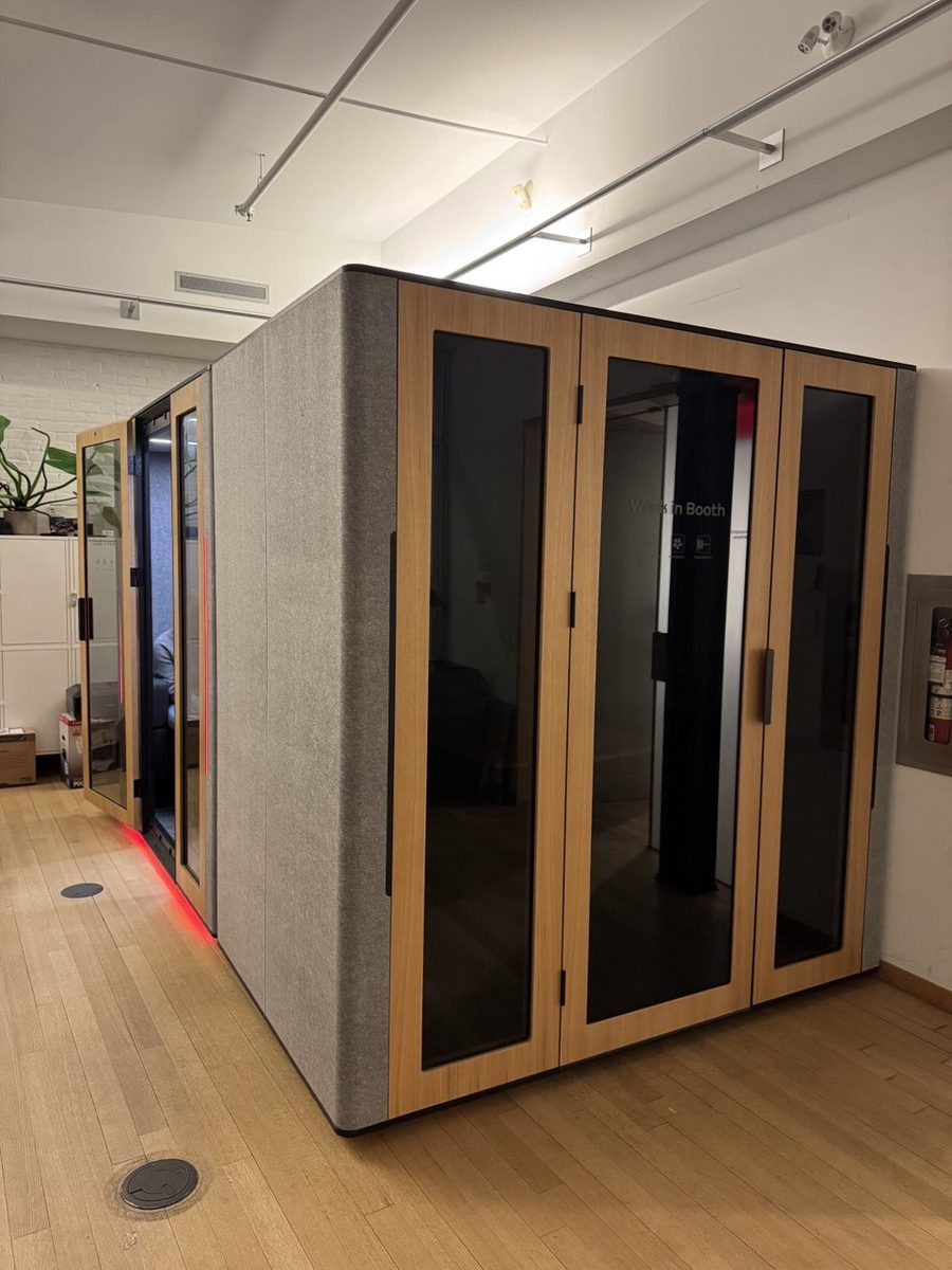Four-person meeting pod with a table and bench seating