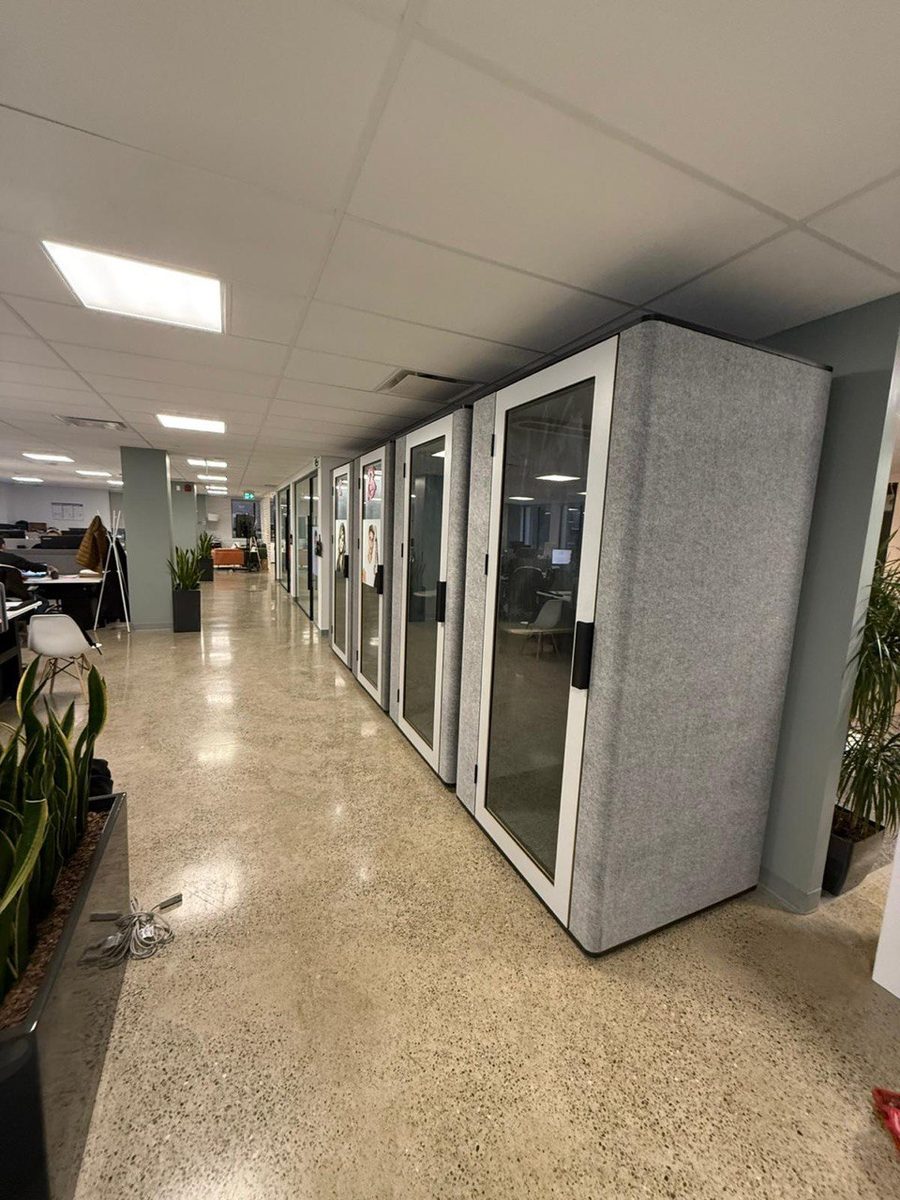 Row of phone booths installed under exposed ducts