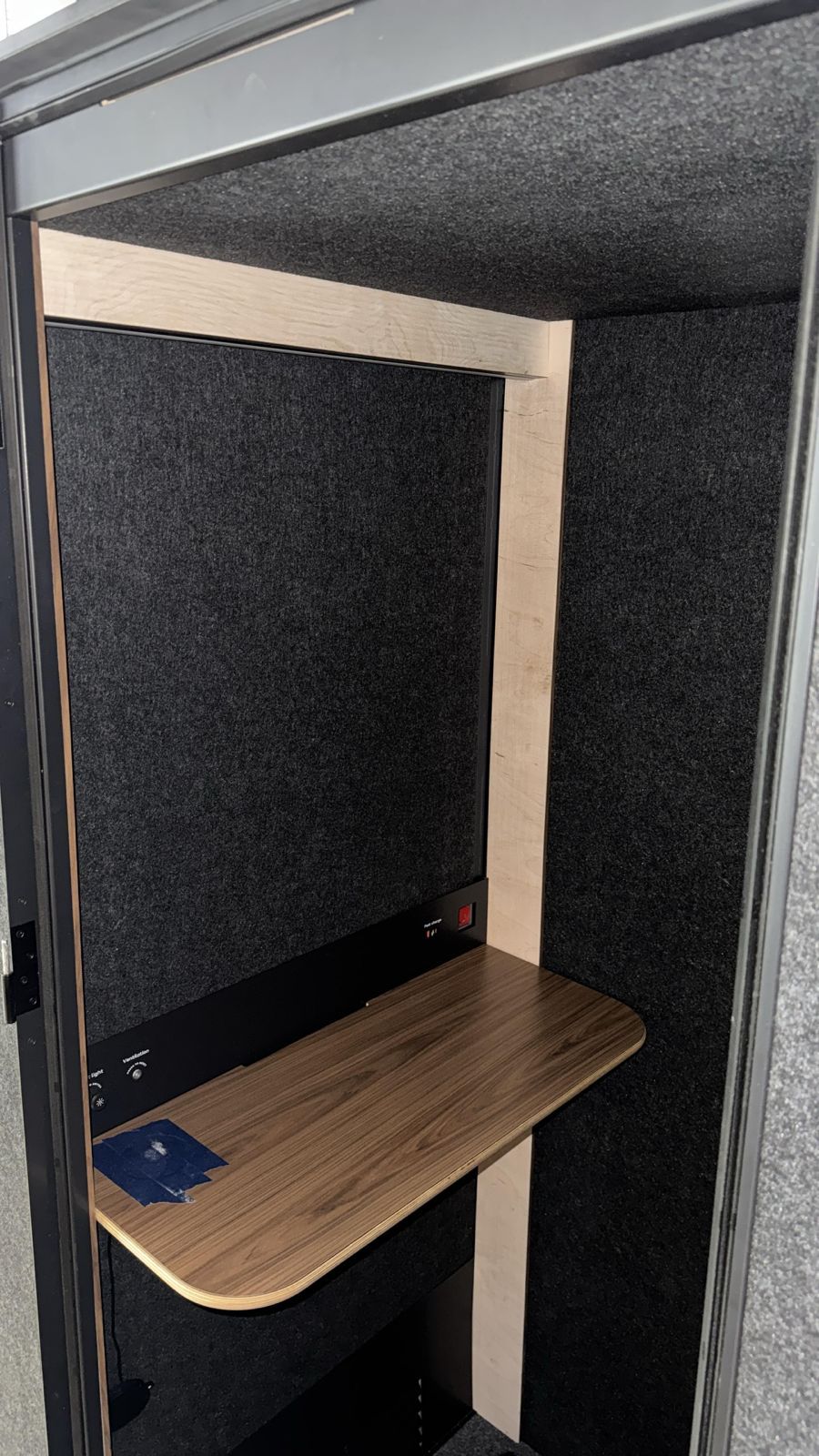 Grey Peacock installer assembling an office phone booth in a Toronto office